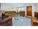 Living room featuring brown reclining sofas and a glass-top coffee table at 3423 Eisenhower Dr, Holiday, FL 34691