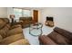 Living room with brown couches, coffee table, and TV at 3423 Eisenhower Dr, Holiday, FL 34691