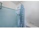 Small bathroom with shower and blue tile at 3423 Eisenhower Dr, Holiday, FL 34691