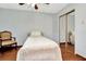 Well-lit bedroom featuring a twin bed, ceiling fan, and mirrored closet doors at 33466 Westwood Dr Dr, Ridge Manor, FL 33523