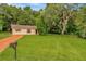 One-story house with orange driveway and large yard at 33466 Westwood Dr Dr, Ridge Manor, FL 33523