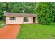One-story house with orange driveway and large yard at 33466 Westwood Dr Dr, Ridge Manor, FL 33523