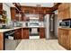 Kitchen with dark wood cabinets, stainless steel appliances, and light flooring at 33466 Westwood Dr Dr, Ridge Manor, FL 33523