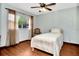 Bright bedroom with a single bed, wood floors, and ample natural light at 33466 Westwood Dr Dr, Ridge Manor, FL 33523