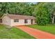 One-story house with orange driveway and large yard at 33466 Westwood Dr Dr, Ridge Manor, FL 33523