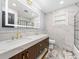Modern bathroom with double vanity, marble tile, and walk-in shower at 2441 69Th S Ave, St Petersburg, FL 33712