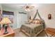 Cozy bedroom with a canopy bed and decorative accents at 5537 Sea Forest Dr # 302, New Port Richey, FL 34652