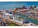 Stunning aerial view of a beachfront community with turquoise waters and modern buildings at 400 150Th Ave # 304, Madeira Beach, FL 33708