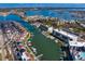Expansive aerial view of the waterfront community showcasing the canals, green roof, and surrounding area at 400 150Th Ave # 304, Madeira Beach, FL 33708