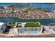 Stunning aerial view of a condo and surrounding waterfront community featuring canals, and green roof space at 400 150Th Ave # 304, Madeira Beach, FL 33708