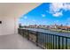 This private balcony has calming water views of the docks, buildings, boats, and blue skies at 400 150Th Ave # 304, Madeira Beach, FL 33708