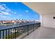 This private balcony has calming water views of the docks, buildings, boats, and blue skies at 400 150Th Ave # 304, Madeira Beach, FL 33708