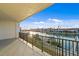 Balcony view of waterfront community, showcasing boats and nearby residences on a sunny day at 400 150Th Ave # 304, Madeira Beach, FL 33708