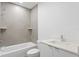 Modern bathroom featuring tiled shower/tub combination with floating shelves and a white vanity at 400 150Th Ave # 304, Madeira Beach, FL 33708
