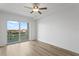 Bright bedroom features wood flooring and large glass doors leading to a private balcony with a water view at 400 150Th Ave # 304, Madeira Beach, FL 33708