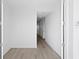 Bright hallway with modern wood flooring and clean, white walls at 400 150Th Ave # 304, Madeira Beach, FL 33708