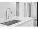 Island sink and faucet in modern kitchen with stainless steel appliances at 400 150Th Ave # 304, Madeira Beach, FL 33708