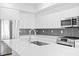 Modern kitchen featuring stainless steel appliances, gray backsplash, and an island at 400 150Th Ave # 304, Madeira Beach, FL 33708