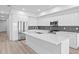 Modern kitchen featuring stainless steel appliances, a large island, and sleek white cabinetry at 400 150Th Ave # 304, Madeira Beach, FL 33708