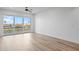 Bright living room features wood flooring and large glass doors leading to a private balcony with a water view at 400 150Th Ave # 304, Madeira Beach, FL 33708