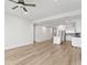 Open-concept living room with modern kitchen and light wood floors at 400 150Th Ave # 304, Madeira Beach, FL 33708