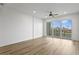 Bright living room features wood flooring and large glass doors leading to a private balcony with a water view at 400 150Th Ave # 304, Madeira Beach, FL 33708
