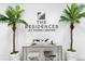 Welcoming lobby featuring The Residences at Town Center signage, plants, and stylish furniture at 400 150Th Ave # 304, Madeira Beach, FL 33708