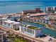 Stunning aerial view of waterfront condos, boat docks, and the beautiful ocean coastline on a sunny day at 400 150Th Ave # 305, Madeira Beach, FL 33708