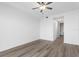 A bright, minimalist bedroom with wood-look floors and an entrance to the bathroom at 400 150Th Ave # 305, Madeira Beach, FL 33708