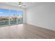 Bright bedroom featuring wood floors and large sliding doors to balcony with a view at 400 150Th Ave # 305, Madeira Beach, FL 33708