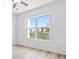 Bright bedroom with light hardwood floors, a ceiling fan, and a window with a nice view at 400 150Th Ave # 305, Madeira Beach, FL 33708