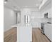 Modern white kitchen featuring a large island, stainless steel appliances, and sleek cabinetry at 400 150Th Ave # 305, Madeira Beach, FL 33708
