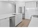 Bright, modern kitchen with stainless steel appliances and a large island with quartz countertops at 400 150Th Ave # 305, Madeira Beach, FL 33708
