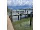 Wooden dock extending into the water, ideal for boating enthusiasts at 15318 Harbor Dr, Madeira Beach, FL 33708