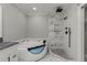 Bathroom with marble shower, soaking tub, and dark vanity at 211 Dolphin Pt # 501, Clearwater, FL 33767