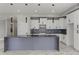 Modern kitchen featuring white cabinets, marble countertops, and stylish pendant lighting at 211 Dolphin Pt # 501, Clearwater, FL 33767