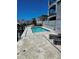 Community pool with stone tile deck and lounge chairs at 211 Dolphin Pt # 501, Clearwater, FL 33767