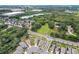 Aerial view of neighborhood with green landscape and houses in distance at 10913 Trailing Vine Dr, Tampa, FL 33610