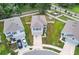 An aerial view of a two-story home with a gray roof, fenced yard, and a driveway with two cars at 10913 Trailing Vine Dr, Tampa, FL 33610