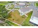 An aerial view of a large backyard with white fence, some small trees and a storage shed at 10913 Trailing Vine Dr, Tampa, FL 33610