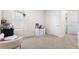 Cozy bedroom with neutral carpet, a large window, and a cute chair with stuffed animals at 10913 Trailing Vine Dr, Tampa, FL 33610