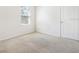 Cozy bedroom with neutral carpet, a large window, and natural light at 10913 Trailing Vine Dr, Tampa, FL 33610