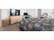 Comfortable bedroom with a dresser, desk, and carpet flooring at 10913 Trailing Vine Dr, Tampa, FL 33610