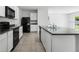 Bright kitchen featuring white cabinetry, granite countertops, and stainless steel appliances at 10913 Trailing Vine Dr, Tampa, FL 33610