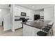 Modern kitchen with white cabinets, granite countertops, and a central island with seating at 10913 Trailing Vine Dr, Tampa, FL 33610