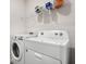 Washer and dryer in laundry room with a wire rack on the wall at 10913 Trailing Vine Dr, Tampa, FL 33610
