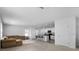 Open-concept living room with carpeted floors, neutral walls, and a view into the kitchen at 10913 Trailing Vine Dr, Tampa, FL 33610