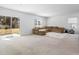 Spacious living room with carpet, a large sectional sofa, and sliding glass doors to the outside at 10913 Trailing Vine Dr, Tampa, FL 33610
