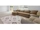 Inviting living room with a large sectional sofa and an decorative area rug at 10913 Trailing Vine Dr, Tampa, FL 33610