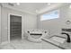 Luxury bathroom with a corner soaking tub, double sinks, and a walk-in closet at 211 Dolphin Pt # 401, Clearwater, FL 33767